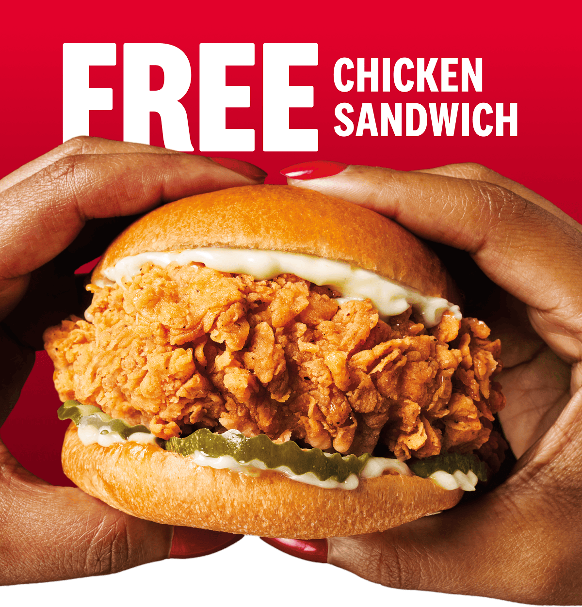 Two hands holding a large chicken sandwich in front of the words Free Chicken Sandwich