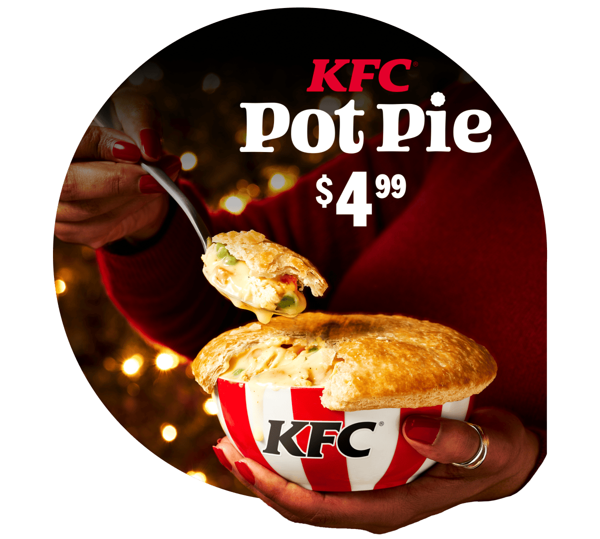 Someone digging into a delicious Pot Pie in front of holiday lights with the workds KFC