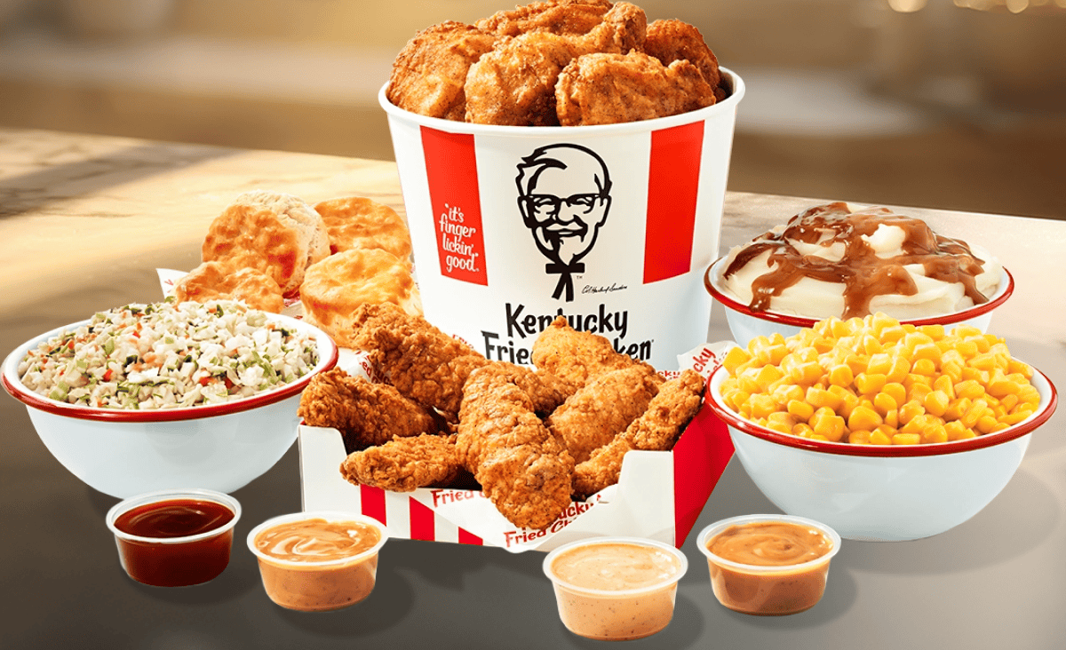 A full spread of KFC Chicken and Tenders with a multitude of sides.