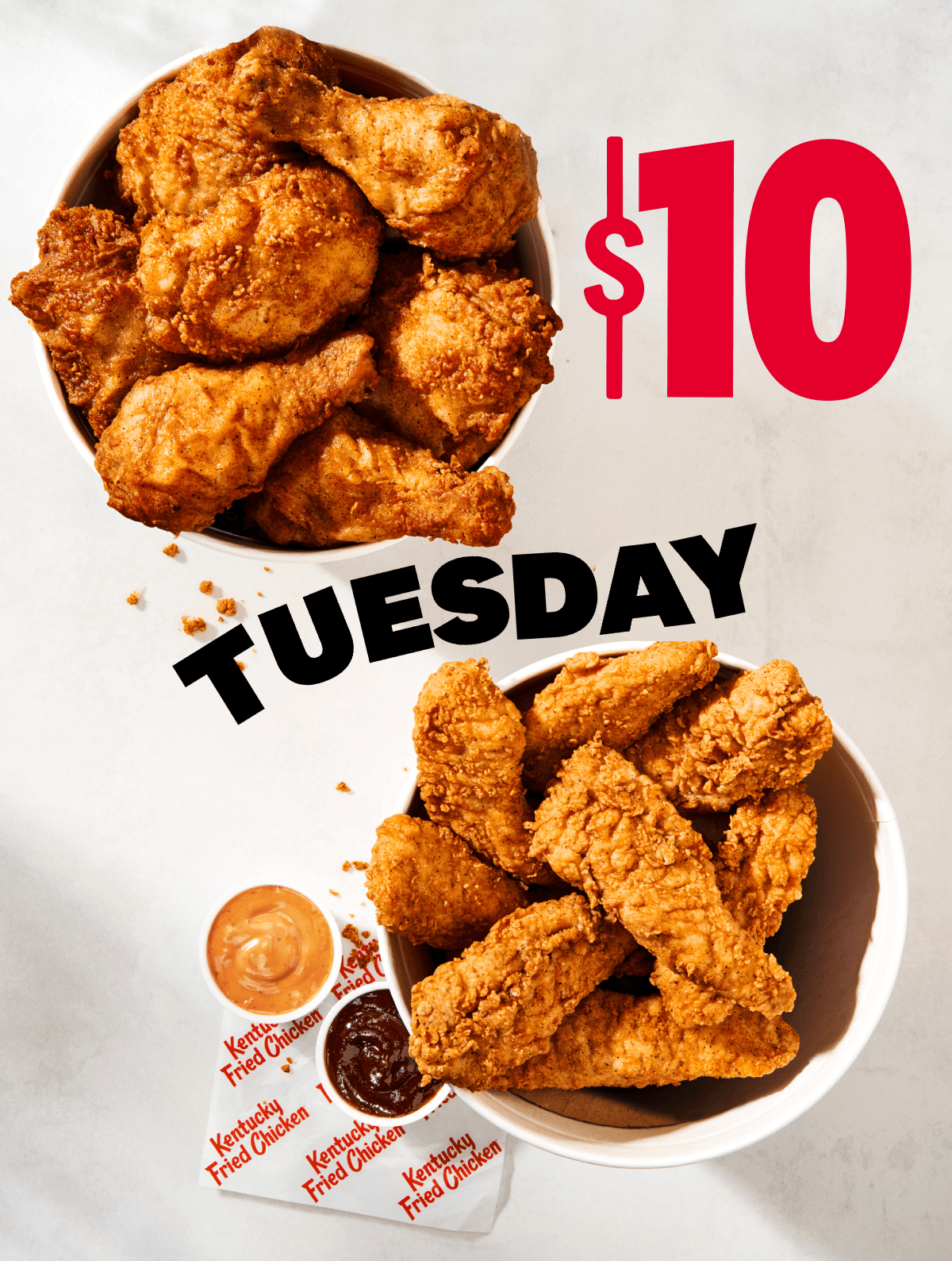 $10 Tuesday. Two KFC buckets, one with Chicken and one with Tenders and sauce.