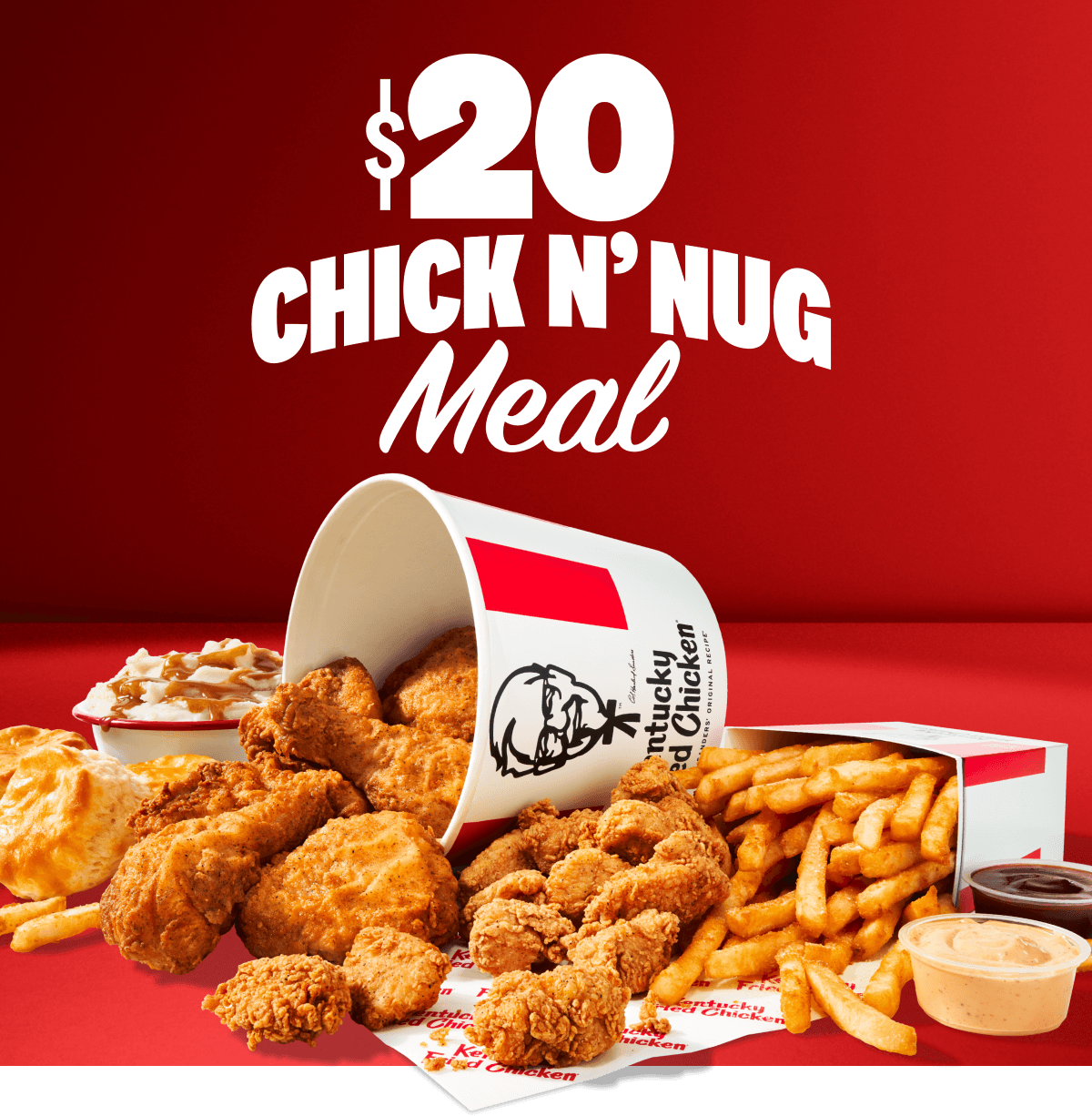 A bucket of chicken spilling out and surrounded by an array of sides.