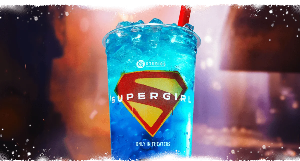A refreshing blue drink in a cup with the Supergirl logo on it.