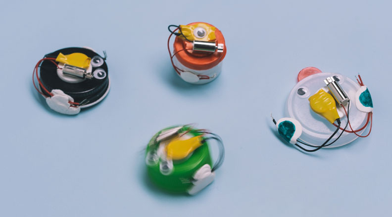 Bottle Cap Bots: Image of four small bots made from bottle caps and wires.
