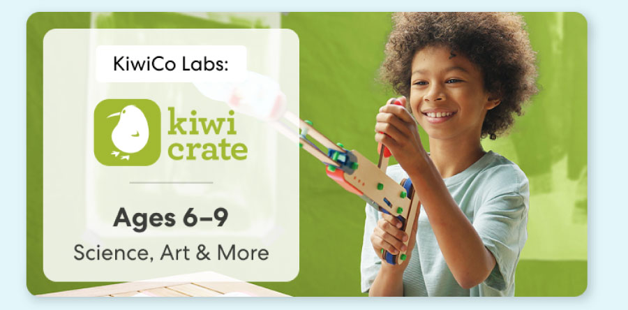 Young child smiling while working on creative KiwiCo Sprout projects, perfect for for play and learn.