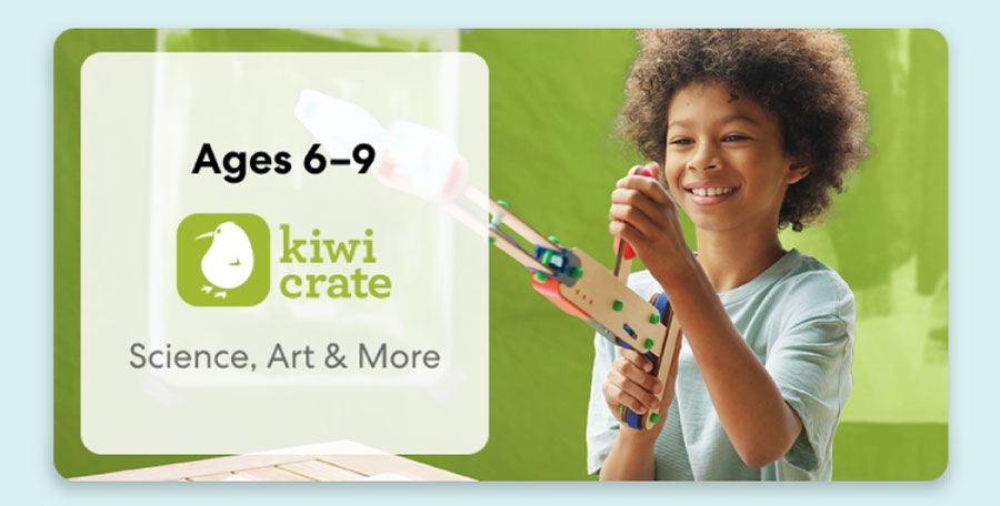 Young girl smiling while working on a science experiment from KiwiCo Labs. Hands-on STEM learning for ages 6–8.