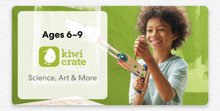 Young girl smiling while working on a science experiment from KiwiCo Labs. Hands-on STEM learning for ages 6–8.