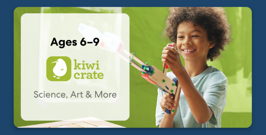 Young girl smiling while working on a science experiment from KiwiCo Labs. Hands-on STEM learning for ages 6–8.