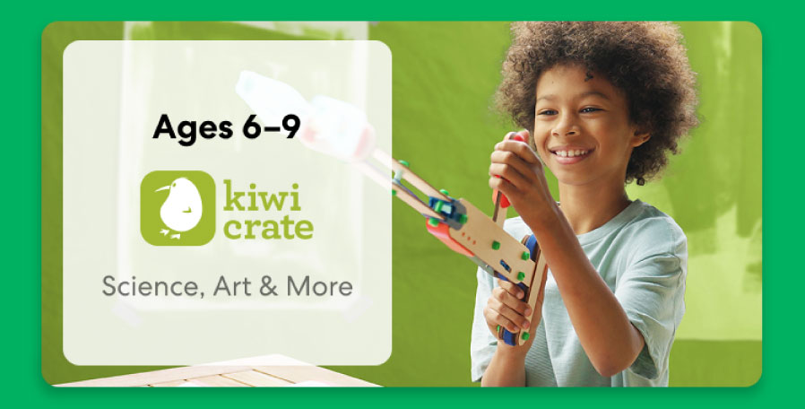 Young girl smiling while working on a science experiment from KiwiCo Labs. Hands-on STEM learning for ages 6–8.