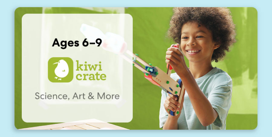 Young child smiling while working on a science experiment from KiwiCo Labs. Hands-on STEM learning for ages 6–9