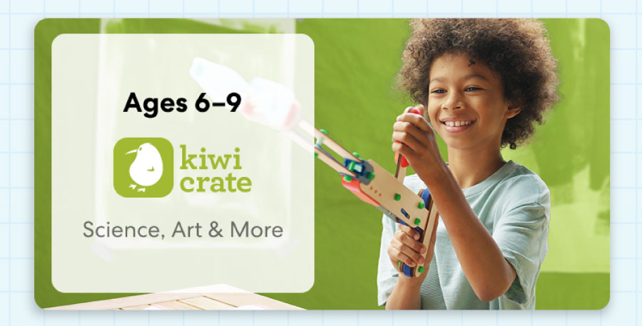 Young child smiling while working on a science experiment from KiwiCo Labs. Hands-on STEM learning for ages 6–9