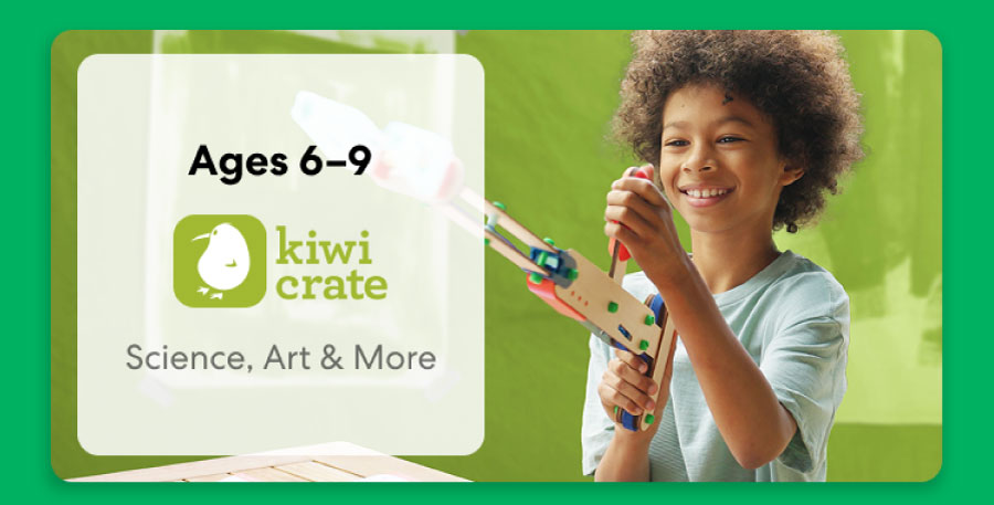 Young child smiling while working on a science experiment from KiwiCo Labs. Hands-on STEM learning for ages 6–9