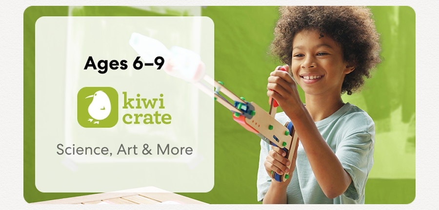 Young child smiling while working on a science experiment from KiwiCo Labs. Hands-on STEM learning for ages 6–9