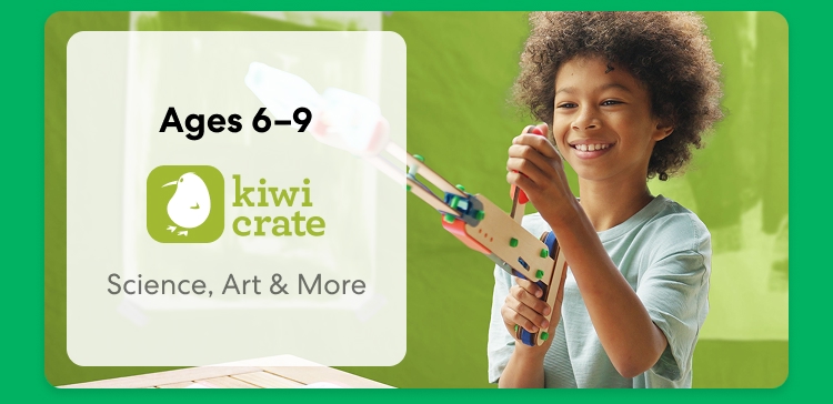 Young child smiling while working on a science experiment from KiwiCo Labs. Hands-on STEM learning for ages 6–9