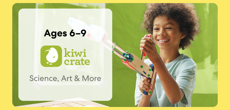 Young child smiling while working on a Kiwi Crate science experiment. Hands-on STEM learning for ages 6 to 9