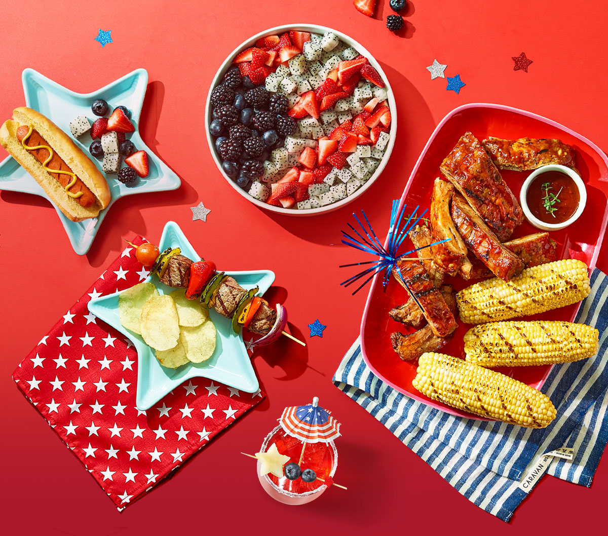 Grilled hot dogs, kebabs, ribs, corn. American flag themed fruit salad, chips, festive drink.