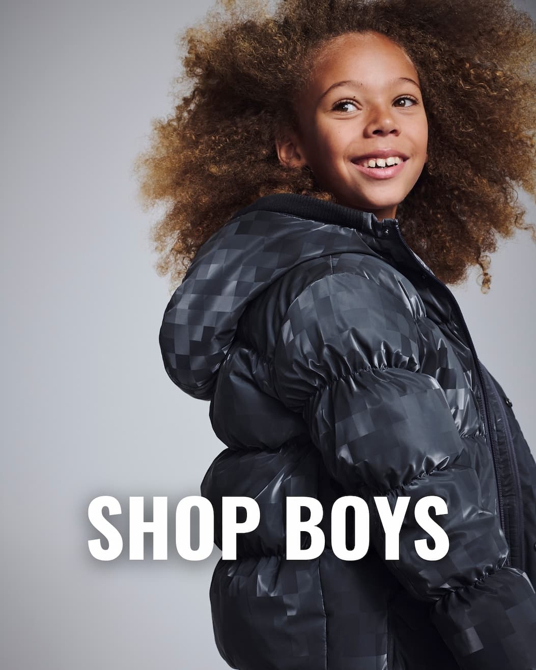 Boys in warm black puffer coat white text shop boys