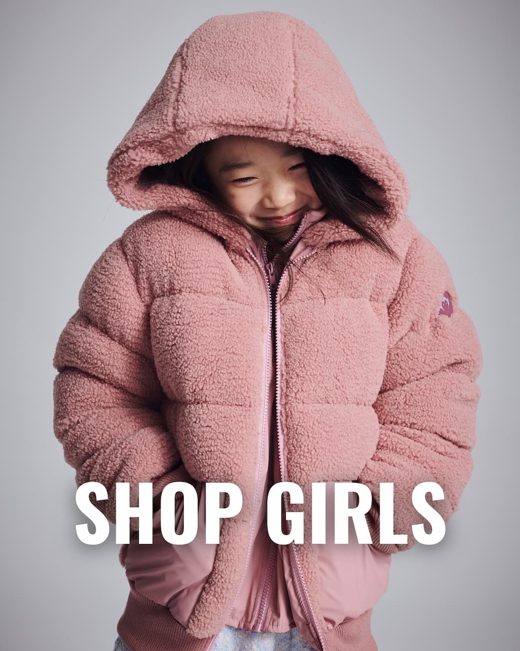 Girl in puffy pink sherpa coat white text shop girls