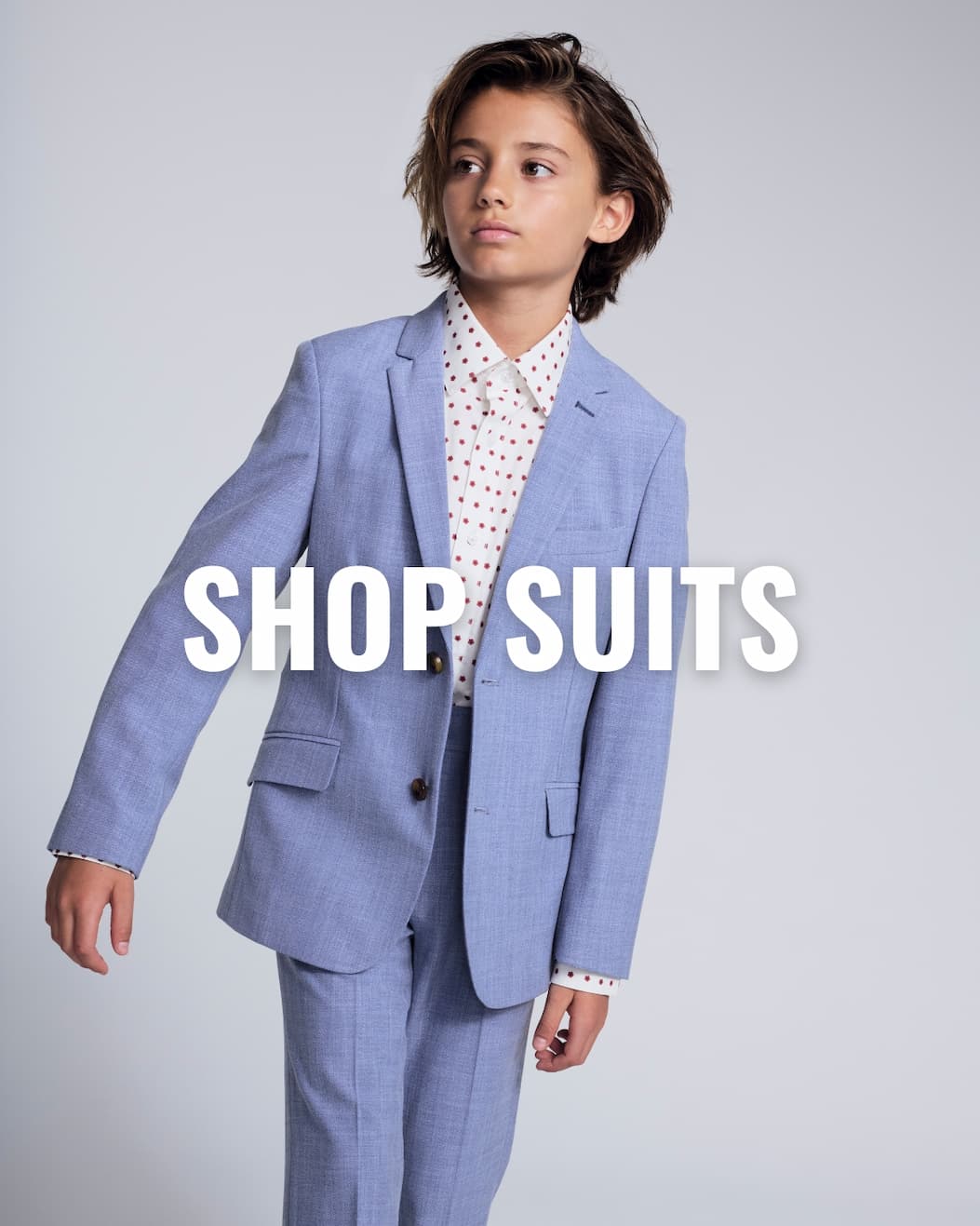 Boy in Light Blue Suit with White Text Shop Suiting