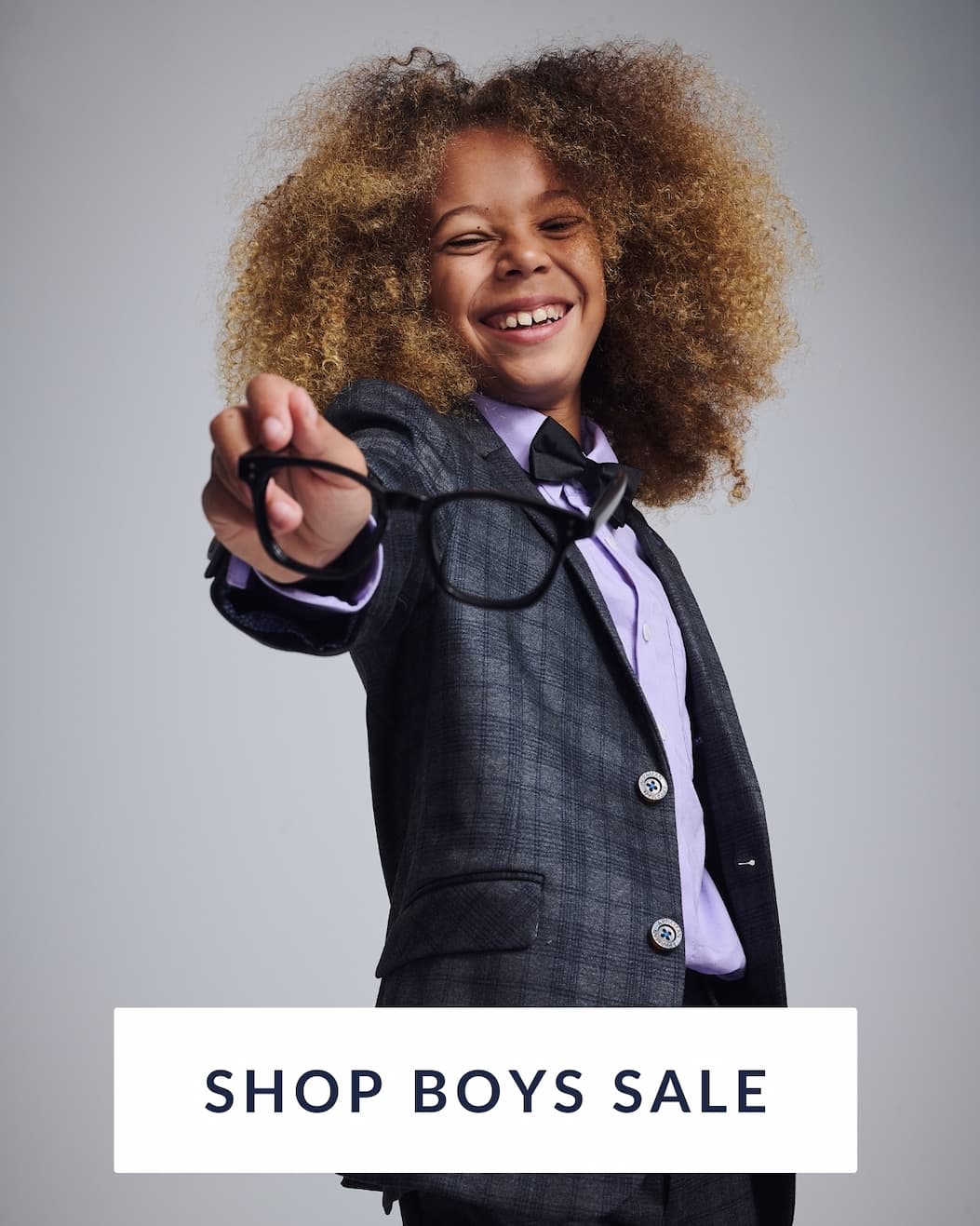 Boy in Grey suit with text shop boys sale