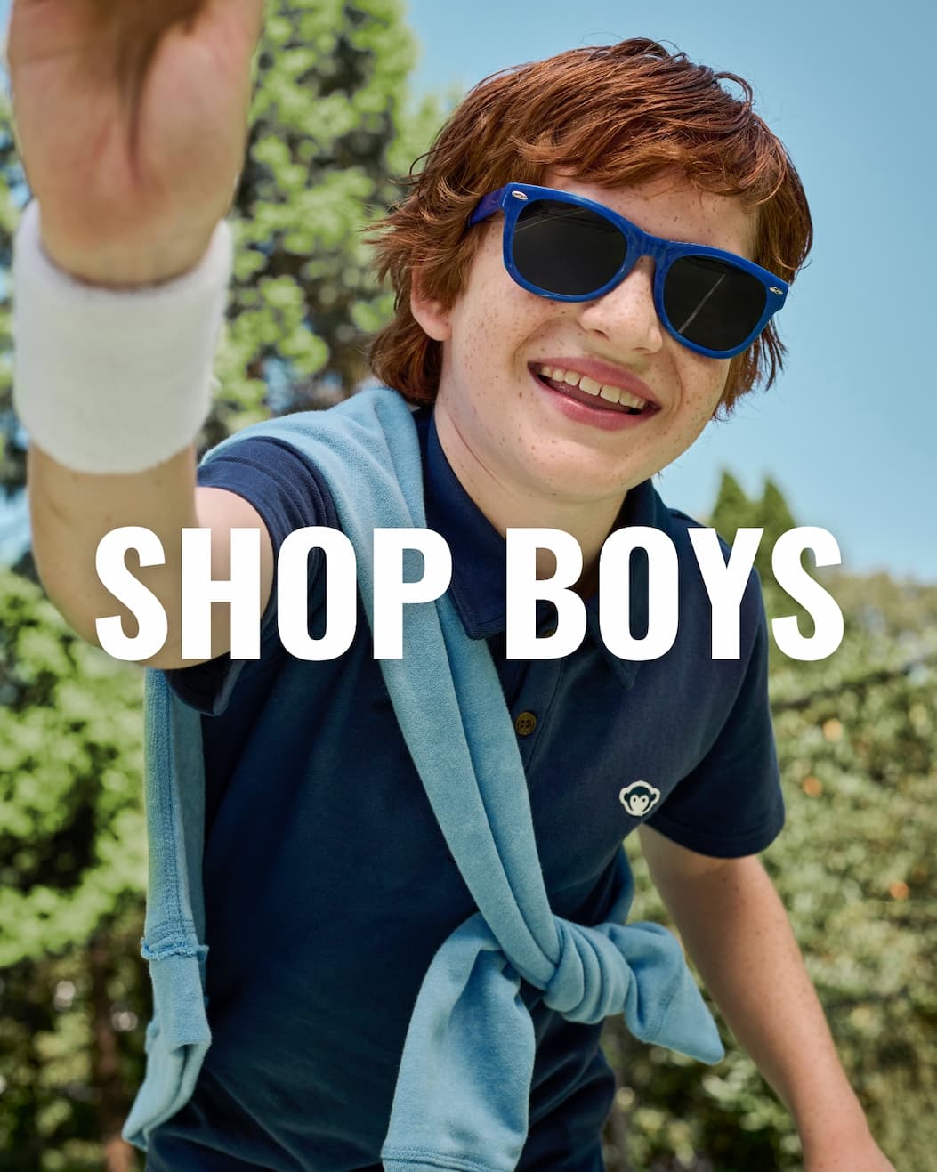 Boy in Navy Collared Shirt with white text shop boys