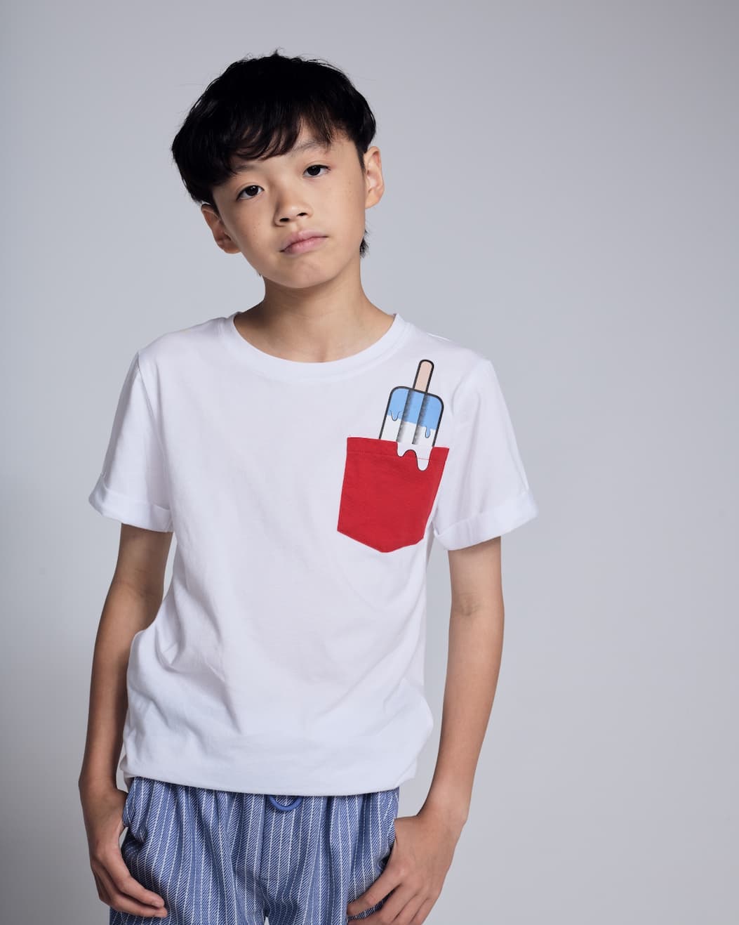 an image of a boy in a white graphic tee