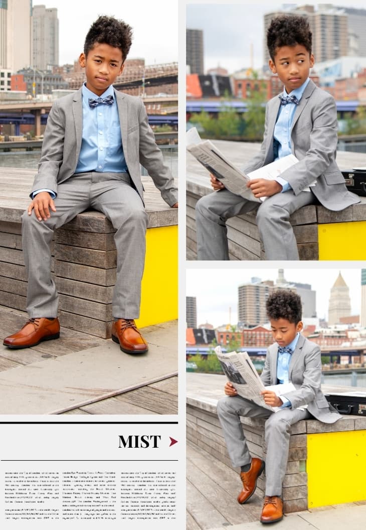 Boy in Appaman light grey suit outside in NYC reading the newspaper