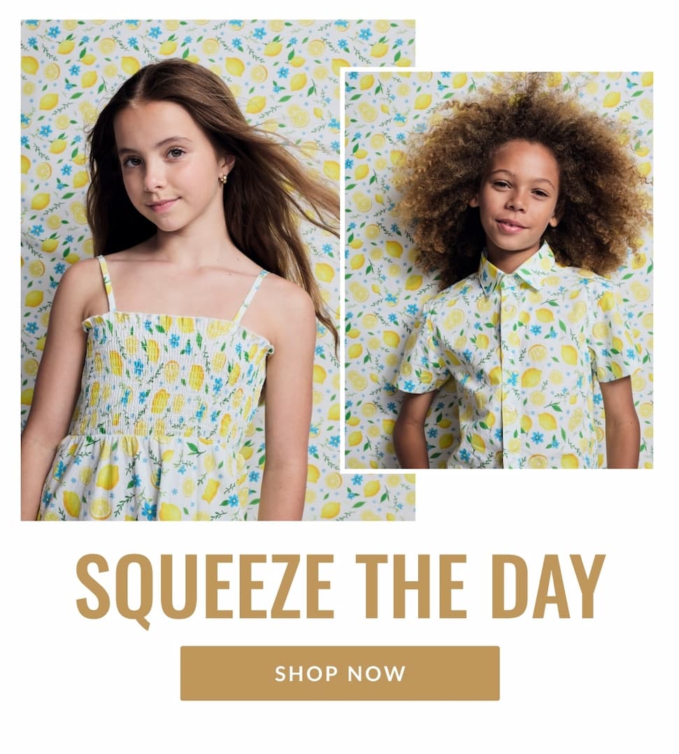 Two kids on lemon print background with matching lemon print outfits
