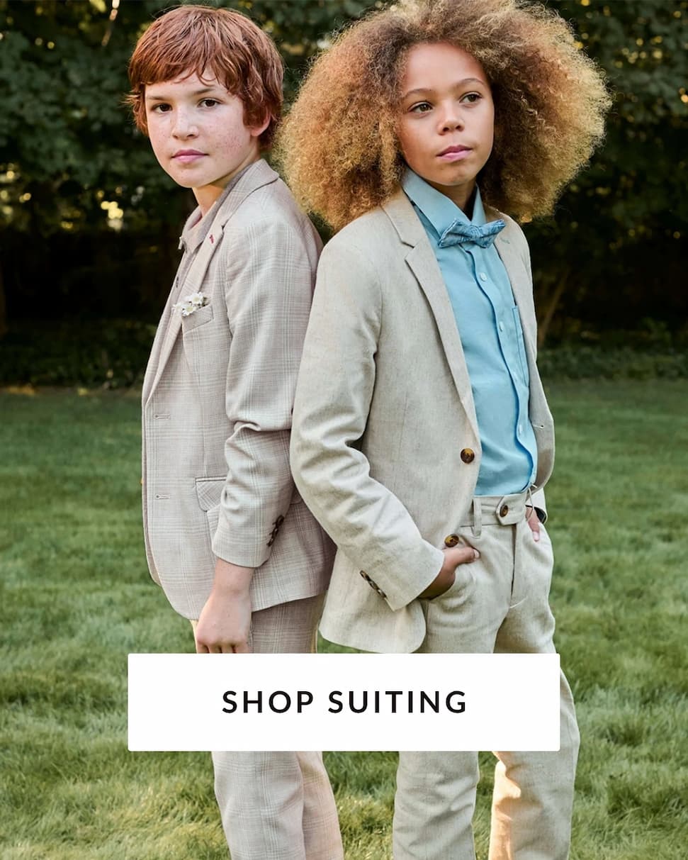 Boys wearing suits outside with text shop suiting
