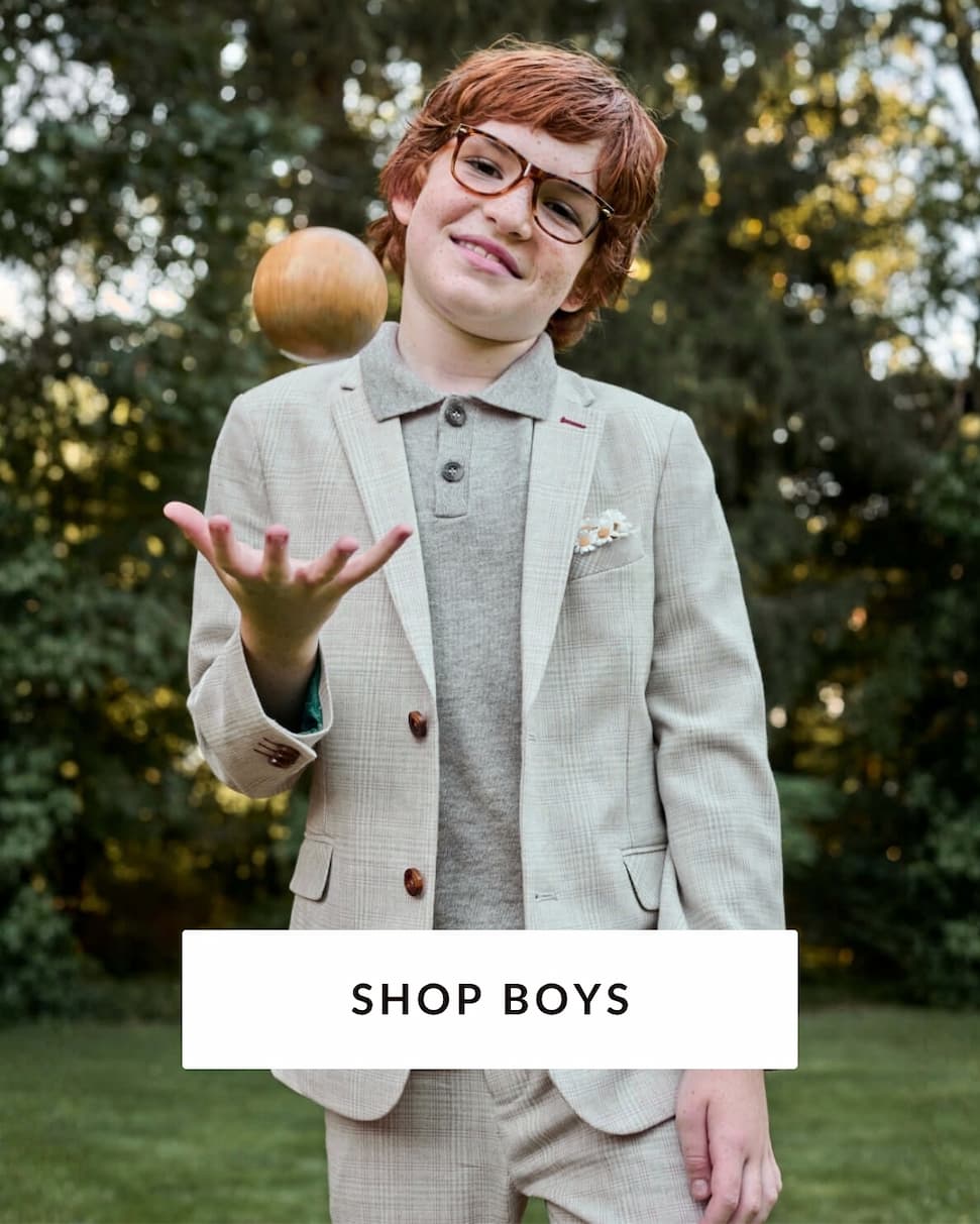 boy outside wearing grey suit with text shop boys