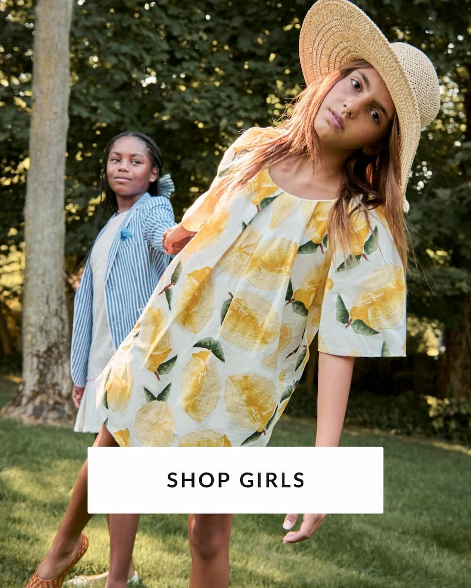 Girls outside wearing dresses with text shop girls