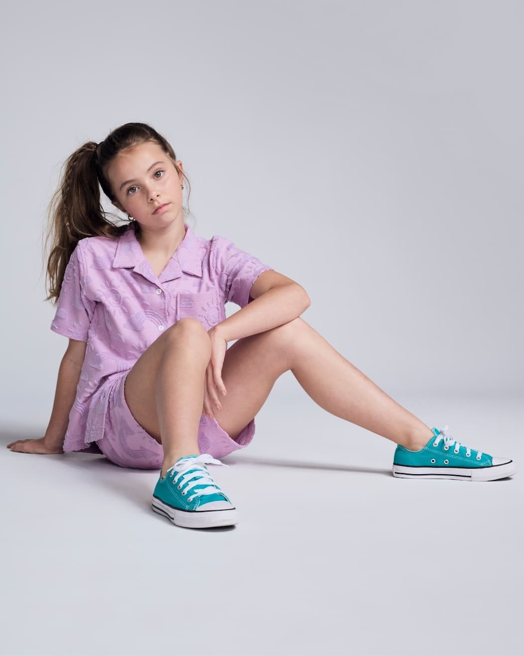 girl on grey background wearing lilac terry set