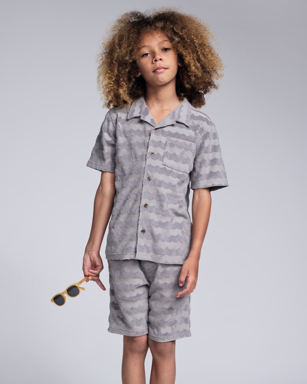 Boy on grey background wearing grey terry set