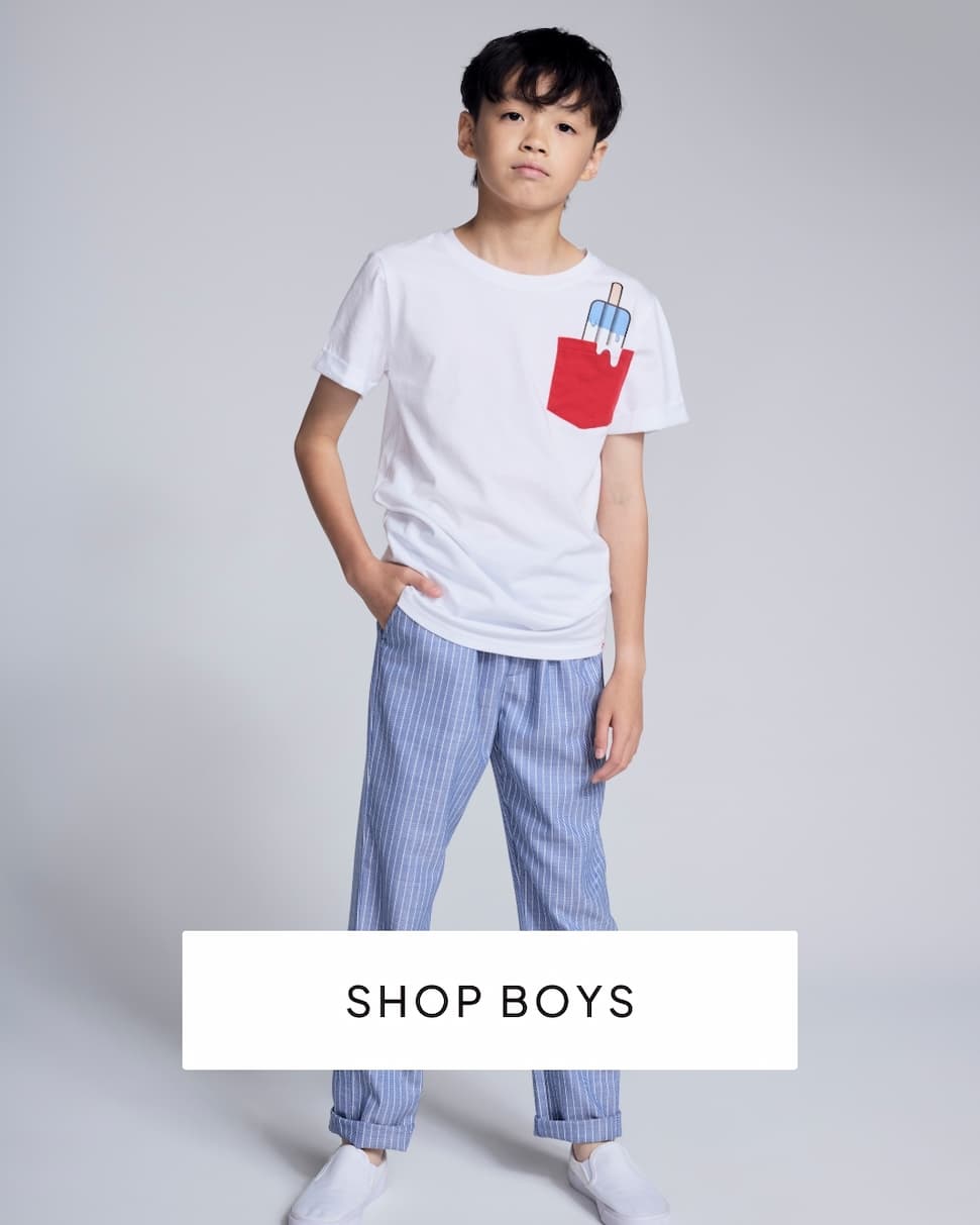 boy wearing white tee and blue pants on grey background with text shop boys