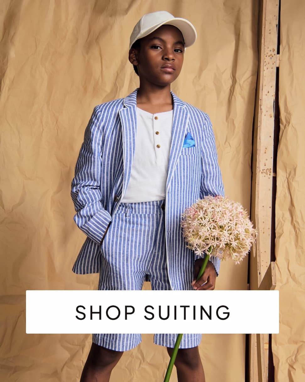 Boy wearing blue and white stripe suit with text shop suiting
