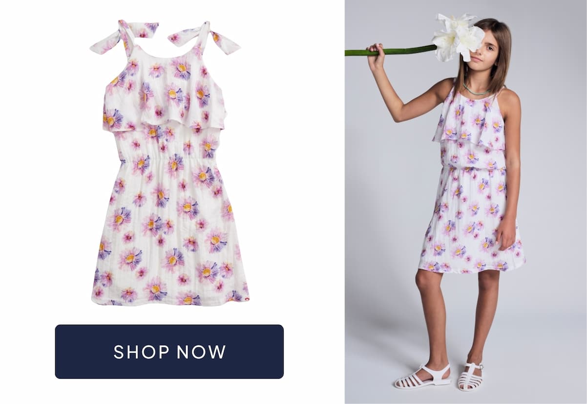 girl wearing white floral dress with image of dress and navy shop now button