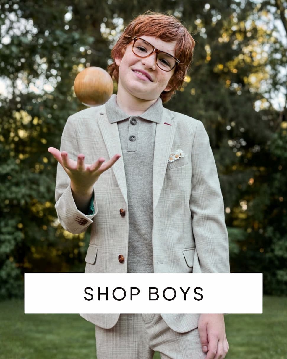 boy wearing grey suit outside with text shop boys