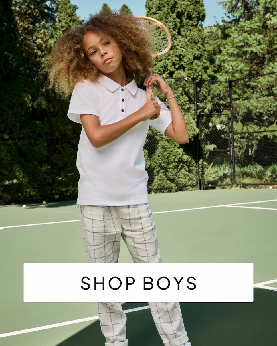 boy wearing white tee and blue pants with text shop boys