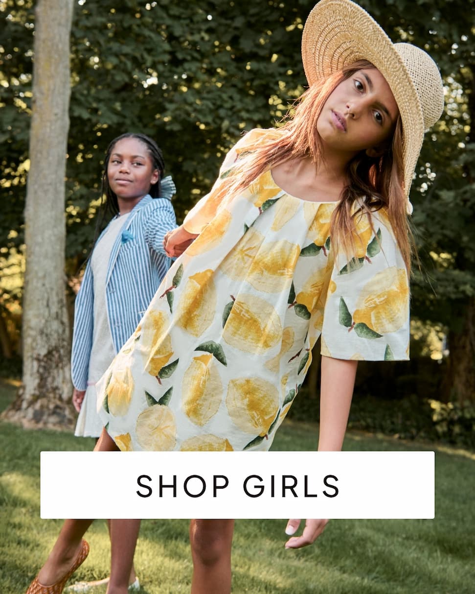 Girls outside wearing dresses with text shop girls