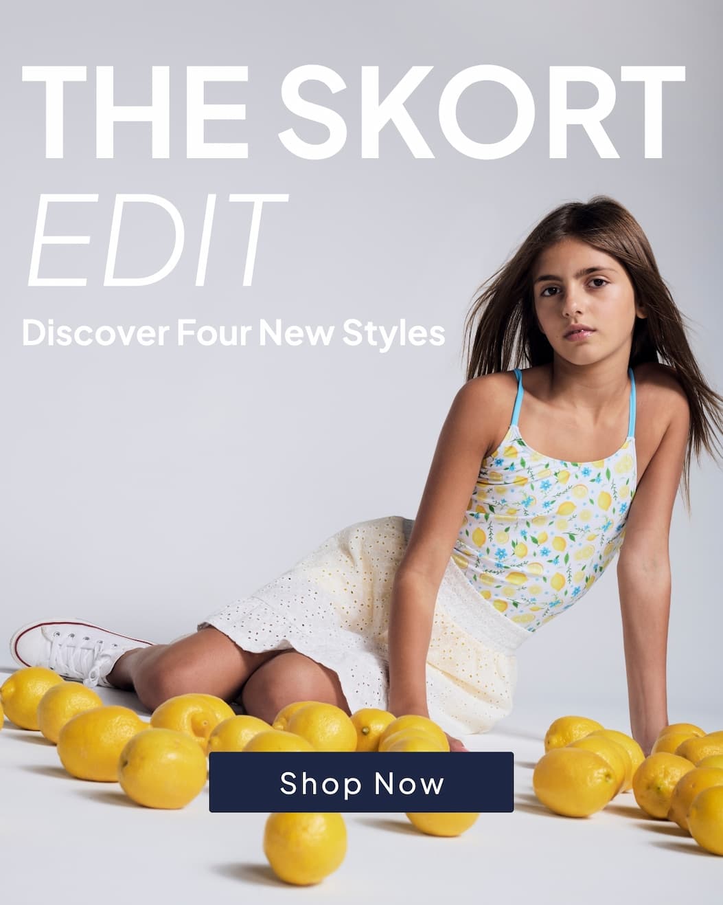 Girl wearing lemon top and yellow skirt with text the skort edit discover four new styles and shop now button