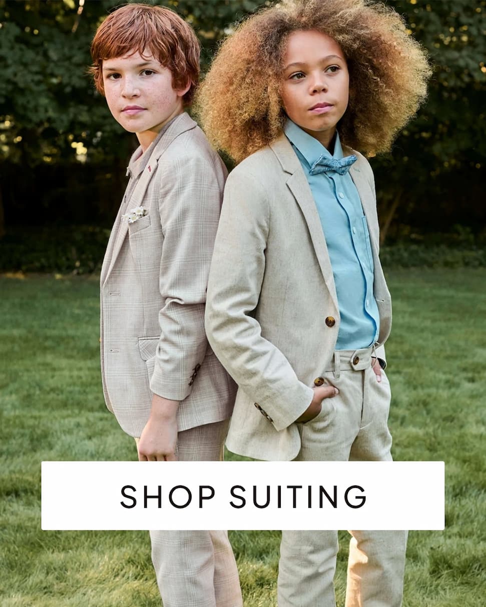 Boys wearing suits outside with text shop suiting
