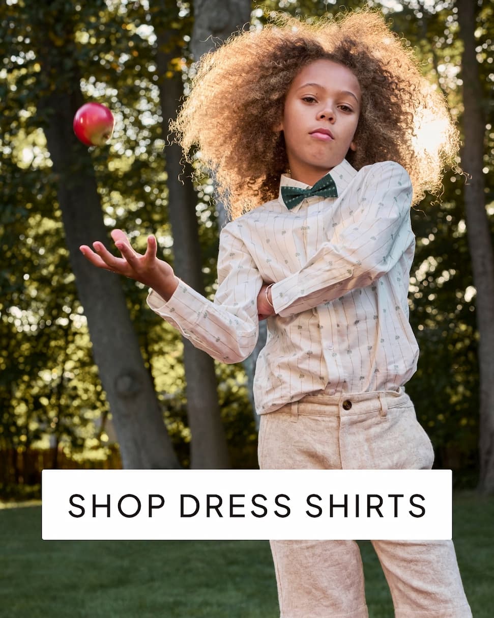 boy outside wearing white dress shirt with text shop dress shirts