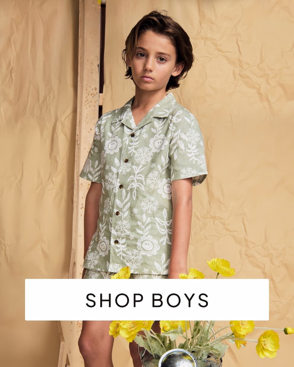boy wearing green set on paper background with text shop boys