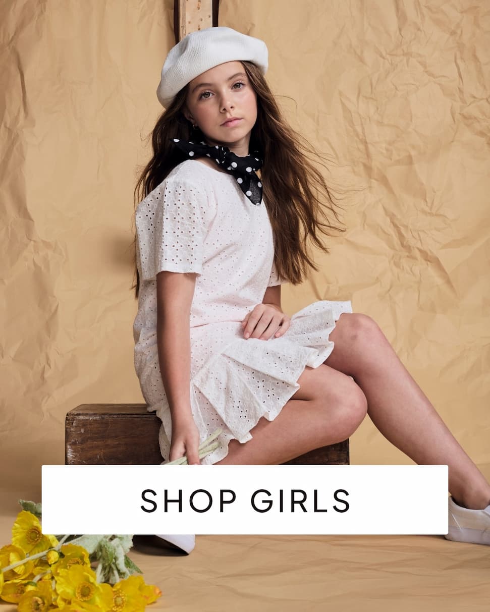Girl wearing pink dress on paper background with text shop girls