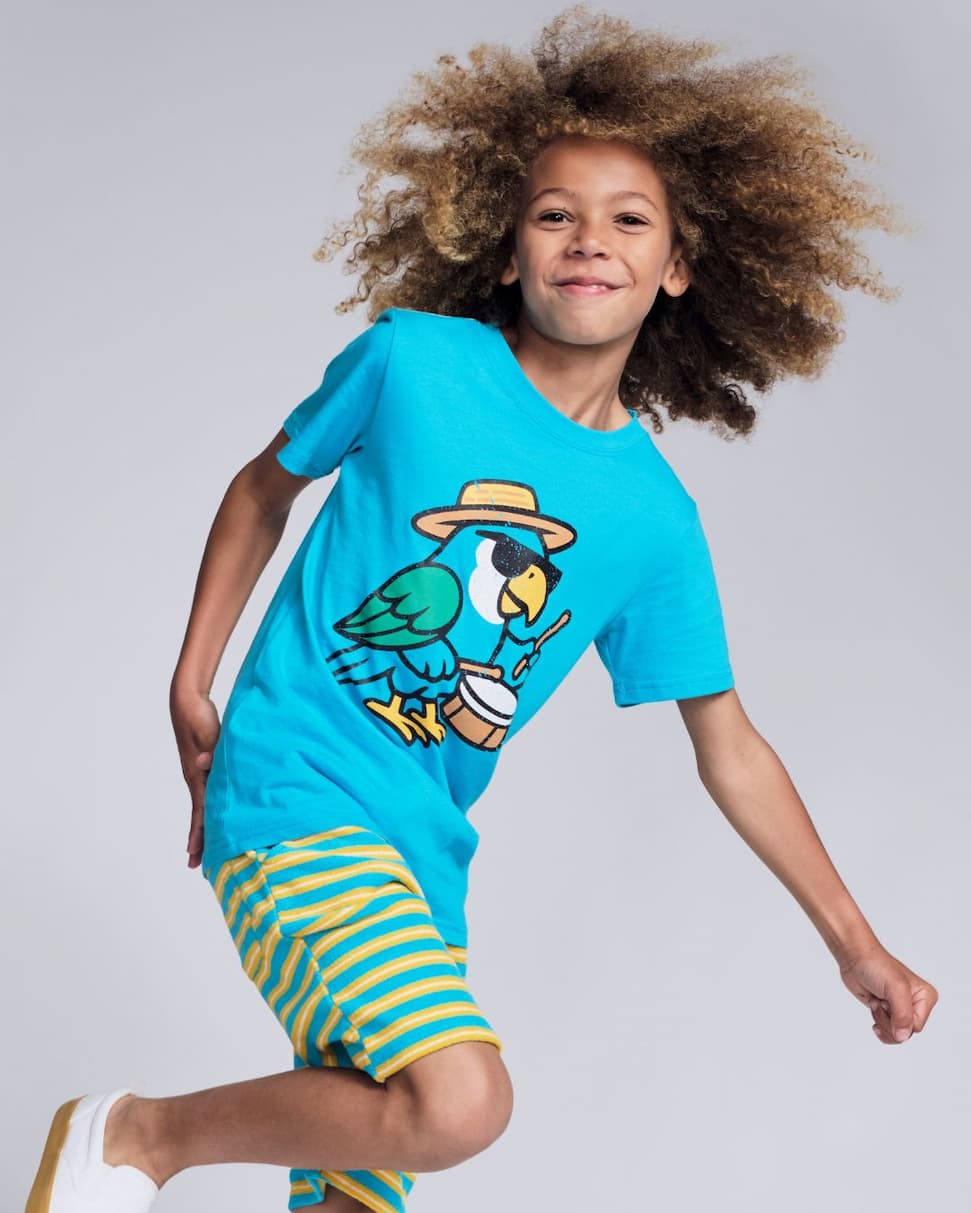 boy wearing teal graphic tee with parrot