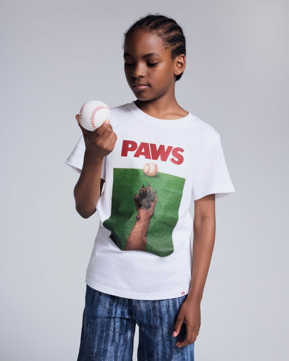 boy wearing white graphic tee with dog paws 