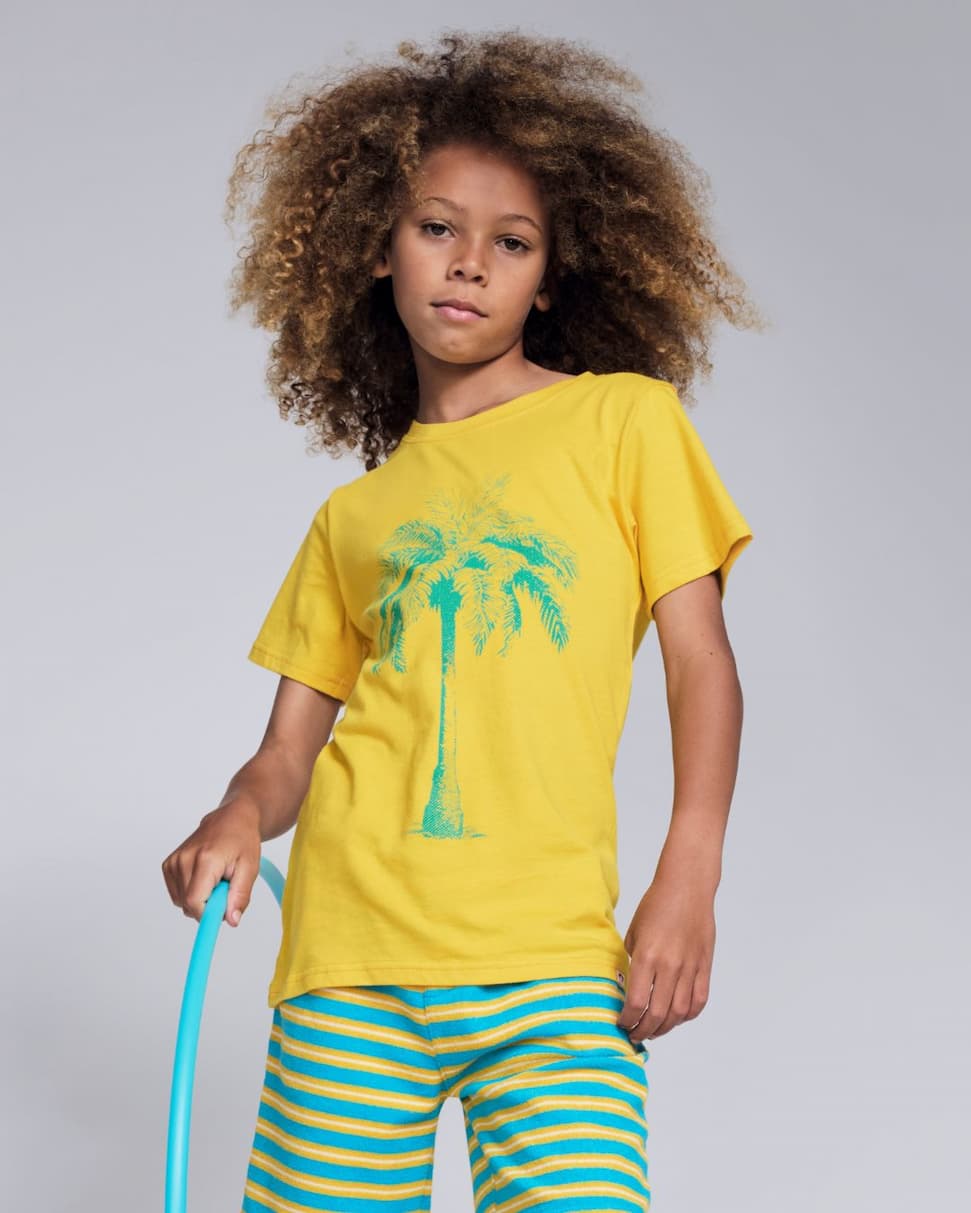 boy wearing yellow graphic tee with palm tree
