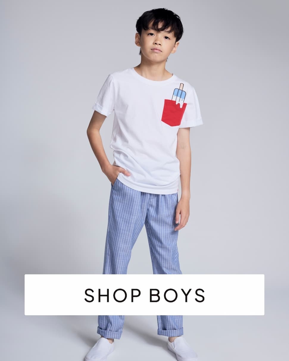 boy wearing white tee and blue pants with text shop boys