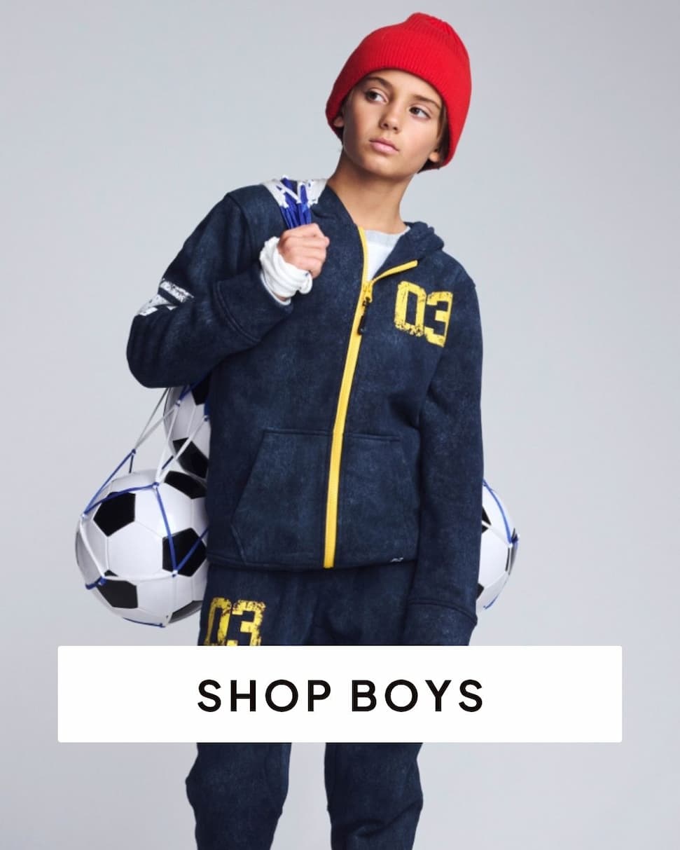 Boy wearing navy sweat set on grey background with text shop boys