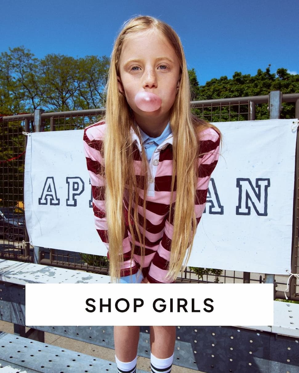 Girl outside wearing pink striped polo dress