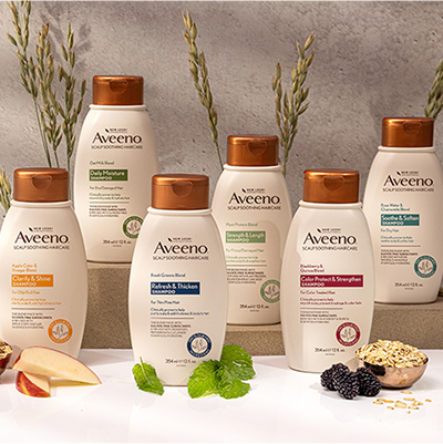 Line up of Aveeno Haircare Shampoo bottles.